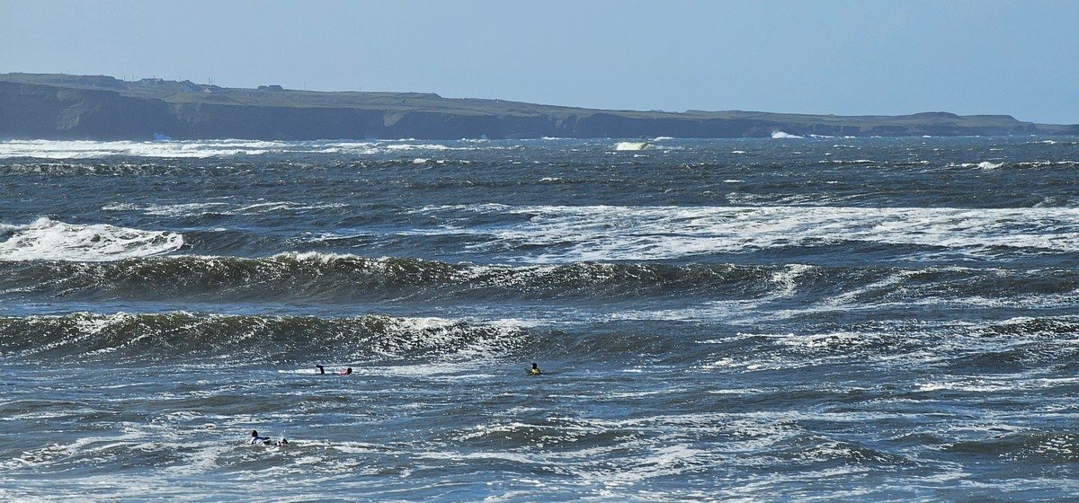 a few junior surf competitors eyeing up potential waves